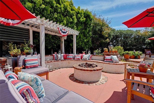 fire pit with trellis for shade. Mature landscaping for privacy