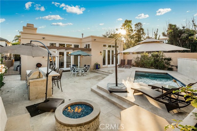 Backyard with Fire Pit / Outdoor Kitchen BBQ & Refrigerator / Pool.