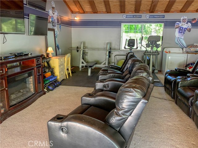 The second two car garage is currently the rumpus room and is ready for Super Bowl parties, movie nights and a full work out! The entire paved pad on this level allows for trailer or additional car storage.