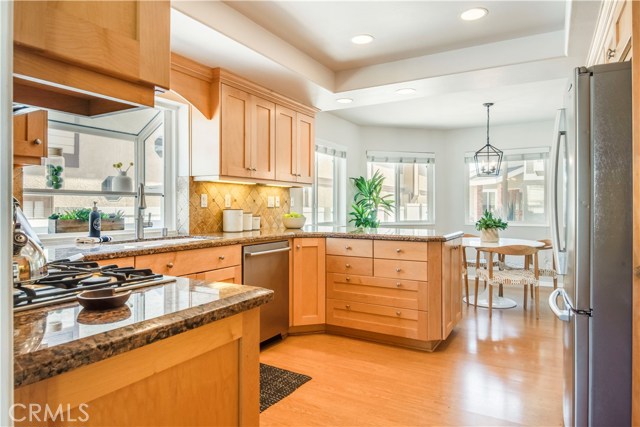 The kitchen is appointed with stainless steel appliances, double convection ovens and a garden window.