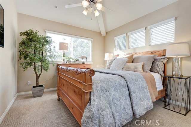 Light, bright and serene 2nd bedroom with vaulted ceilings and baseboards.