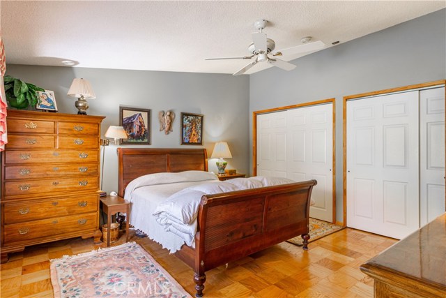 master bedroom with closets and fan