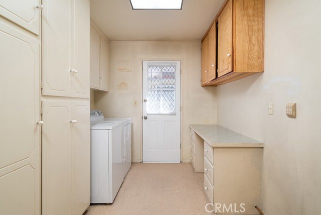 Laundry/utility room is across from kitchen and has a door to east side of home.