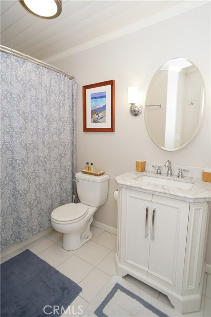 Marble vanity, shiplap ceiling with crown molding.