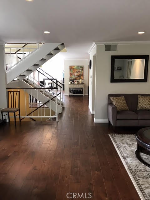 Beautiful hardwood floors throughout the home. This view is from the front patio and through to the second living room.