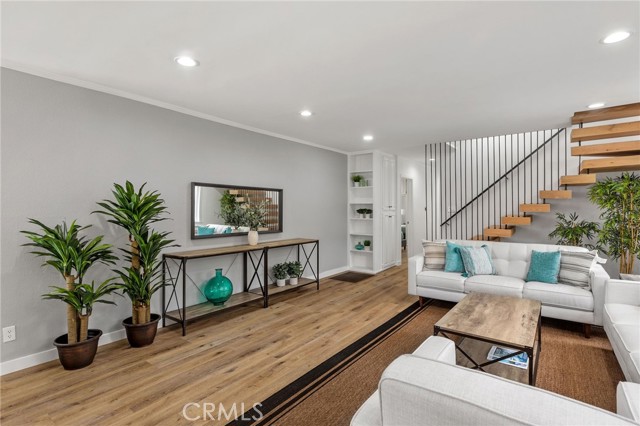 Inviting living room with fresh paint, new canned lighting and custom staircase