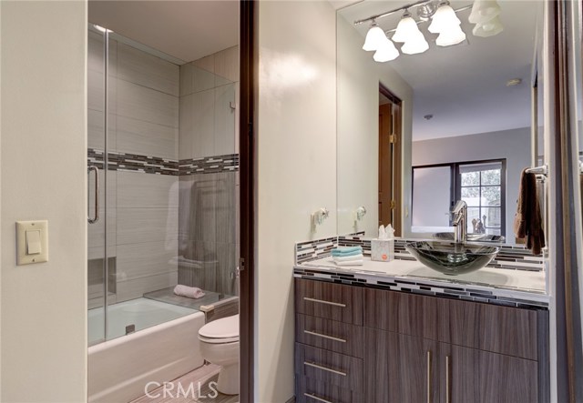 Second bedroom ensuite with tub, shower and separate sink area.