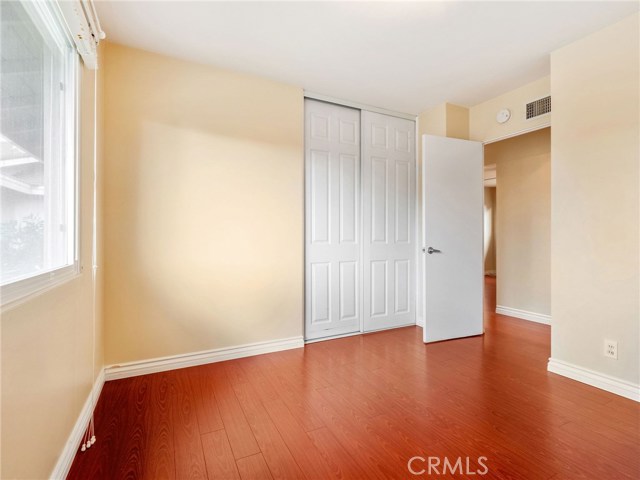 Bedroom #3 with hardwood floors and custom closet built ins.