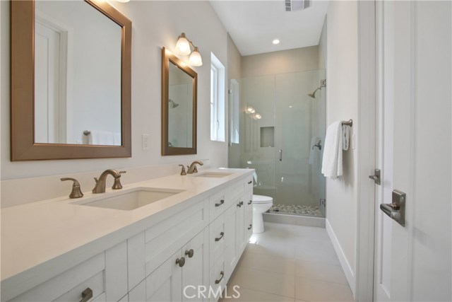 Jack n Jill bathroom w/double sinks, quartz counter tops and Seamless shower.
Both bedrooms on each side.