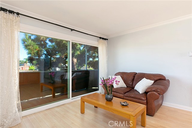 Large sliding glass doors let light flood into the living room, kitchen, and dining ell.