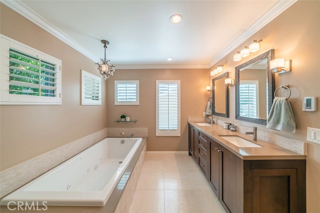 Master Suite bathroom with Caesar Stone counters and stone flooring.