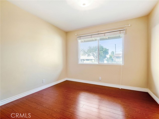 Bedroom #3 with hardwood floors and custom closet built ins.