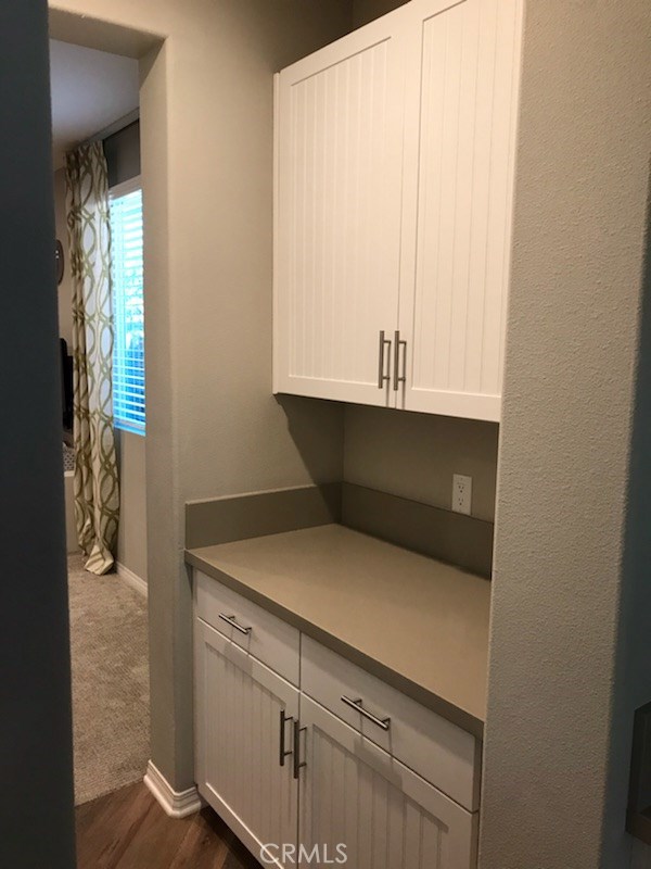 Additional cabinets adjacent to the walk-in pantry.