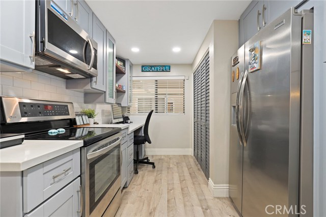 Stainless appliances, including a built in Microwave, build in office space on your left background and laundry closet on the right.