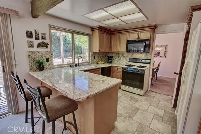 Updated cabinets with beautiful granite counters and tiled flooring.