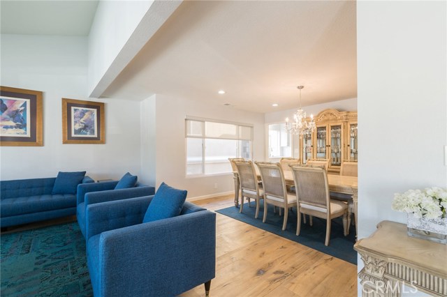 front living room with high ceilings and opening to formal dining room