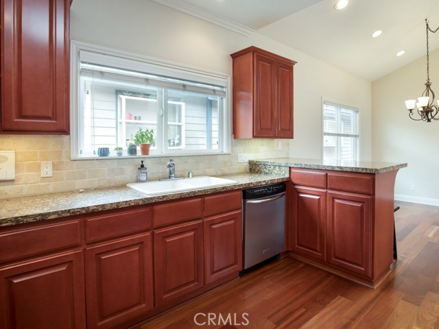 Chef’s kitchen, wood cabinets with granite counters