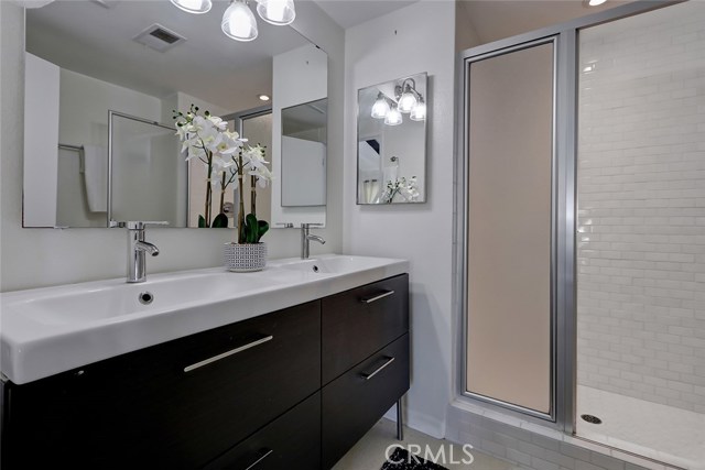 Master bath has dual sinks and an oversized shower with white subway tile!