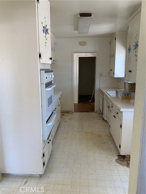 Galley Style Kitchen with Vinyl Flooring and Laminate Countertops