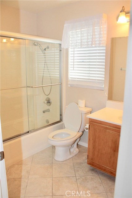 Secondary bathroom with tub and shower and tile flooring