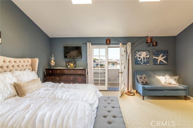 master bedroom with vaulted ceilings & sunlights