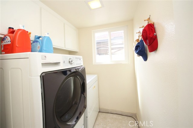 Laundry room with a window and storage