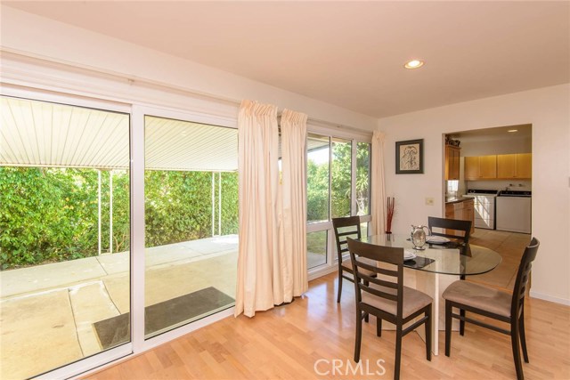 Ample dining area looking out to rear yard with covered patio.