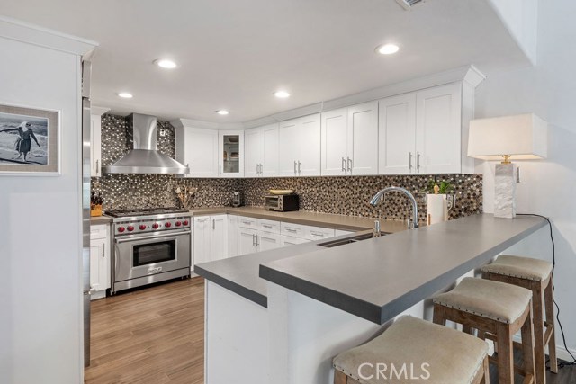 Gorgeous custom kitchen w hardwood floors, quartz counters, stainless appliances