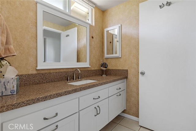 Main bedroom vanity. Tub and shower to right through door.