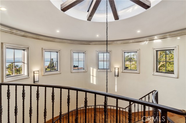 Entryway into the home with domed/cathedral ceiling and views throughout. This room accesses stairs, elevator, and garage.