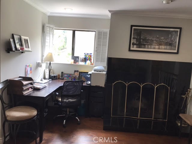 Desk area next to the living room fireplace that has great natural light