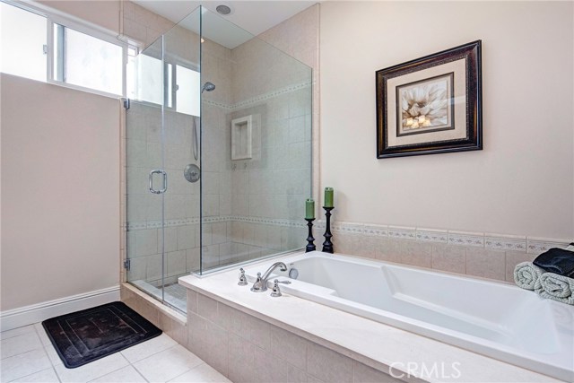 En-suite master bathroom with stone countertop, jetted tub, walk-in shower, and skylight which brings tons of natural light!