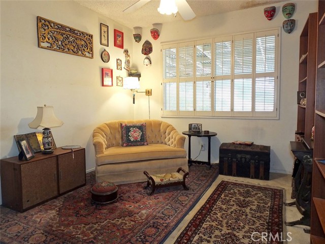 Bedroom with Shutters and Ceiling Fan