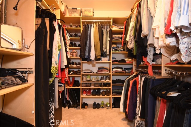 The most thoughtful custom walk in closet that even has organizers for your jewelry, belts, you name it!