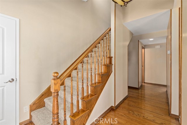 Entry with beautiful oak staircase and storage closet