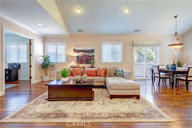 Huge open floor plan, tons of natural light, beautiful engineered hardwood floors, balcony off of the dining area, and adjacent den/office with French doors that could be converted to a 4th bedroom.