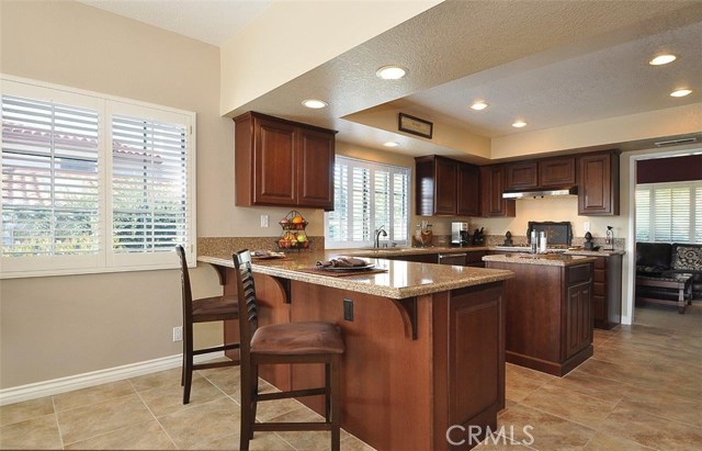 View of kitchen showing breakfast bar, center island and Bosch cooktop and dishwasher