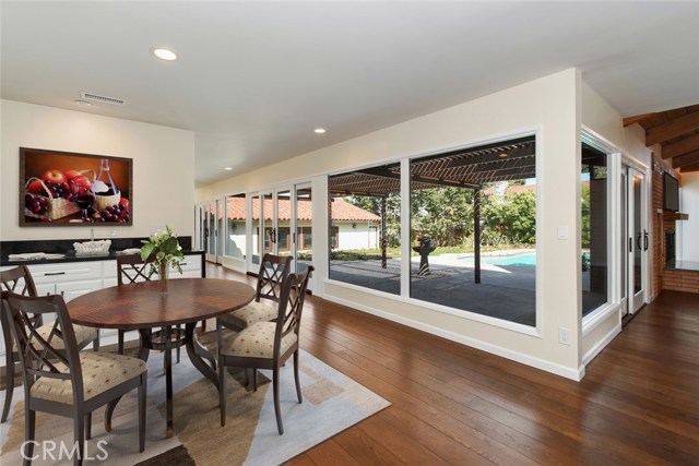 Another place to relax is the breakfast nook with walls of glass overlooking the patio and pool