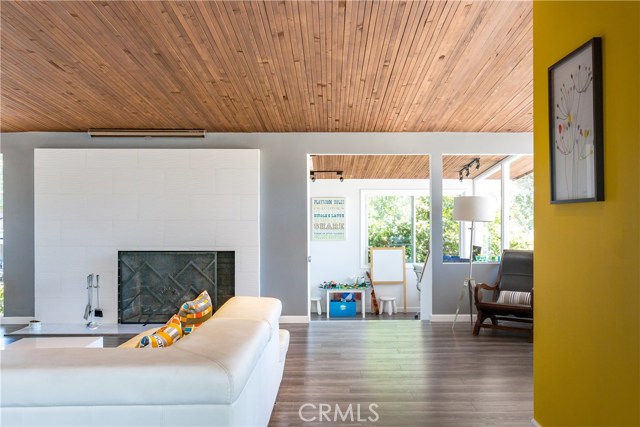 Great room with beautiful wood ceilings, tons of natural light, fireplace and slider to the entertainer's backyard!  You can also see the den/office