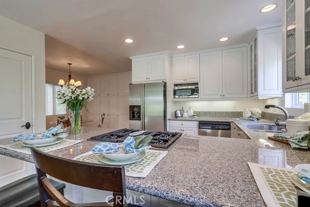 Looking into kitchen from the family room area over the eat up peninsula