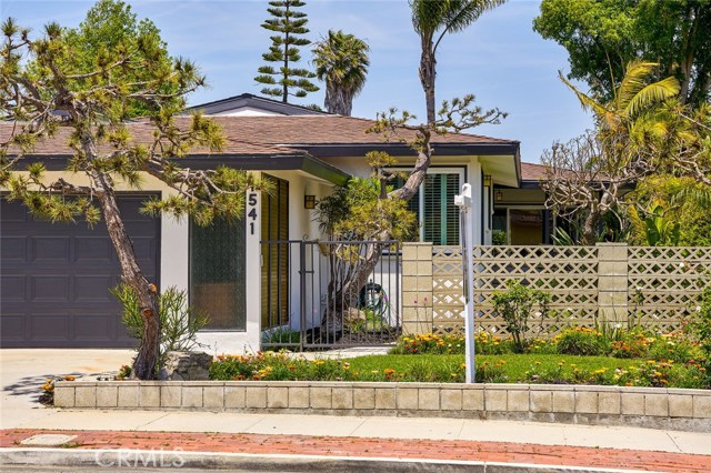 Front yard with gated entry to another enclosed yard and front porch