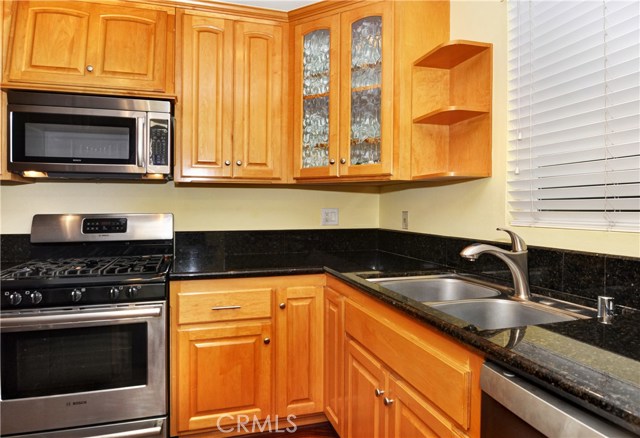 Beautiful Kitchen with 6 burner gas range, Maple cabinets and dark granite counters. Double Stainless Steal sink with newer faucet