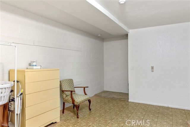 Staircase leads up to entry level at back of picture.