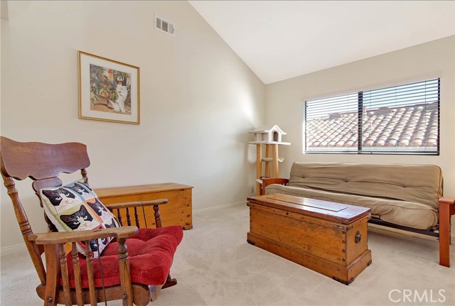 Bedroom with vaulted ceiling.