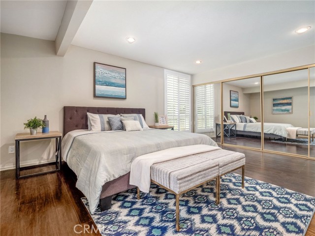 Master Bedroom with Wall of Mirror Sliders of a 2nd Closet