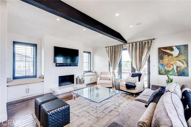 The top floor is where you will find the northwest facing living room that enjoys a cozy fireplace, built in bench seating and 2 terraces to enjoy the ocean view and breeze.