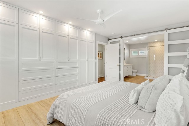 Custom Cabinetry in Primary Bedroom houses lots of drawer, hanging and media space.