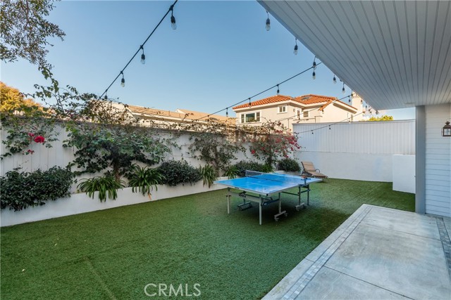 Covered patio and turf yard at back of house