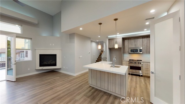 LIVING ROOM, FIREPLACE, ACCESS TO BALCONY ALL IN KEEPING WITH A OPEN CONCEPT FLOORPLAN
