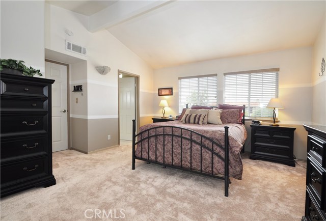 Upstairs Master Bedroom featuring and Ocean View, Vaulted Smooth Ceilings, New Paint and Carpet, Dual Pane Windows and adjacent Bath